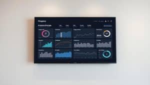 A clean, minimalist sports therapy progress dashboard displayed on a large flat-screen monitor. The dashboard features a series of charts, graphs, and indicators tracking various metrics such as range of motion, pain levels, strength, and flexibility over time. The layout is organized and easy to read, with a sleek, modern aesthetic. The background is a muted, neutral color, allowing the dashboard to take center stage. Soft, diffused lighting illuminates the scene, creating a sense of professionalism and care. The overall impression is one of a well-designed, effective tool for monitoring and measuring the success of a sports therapy program.